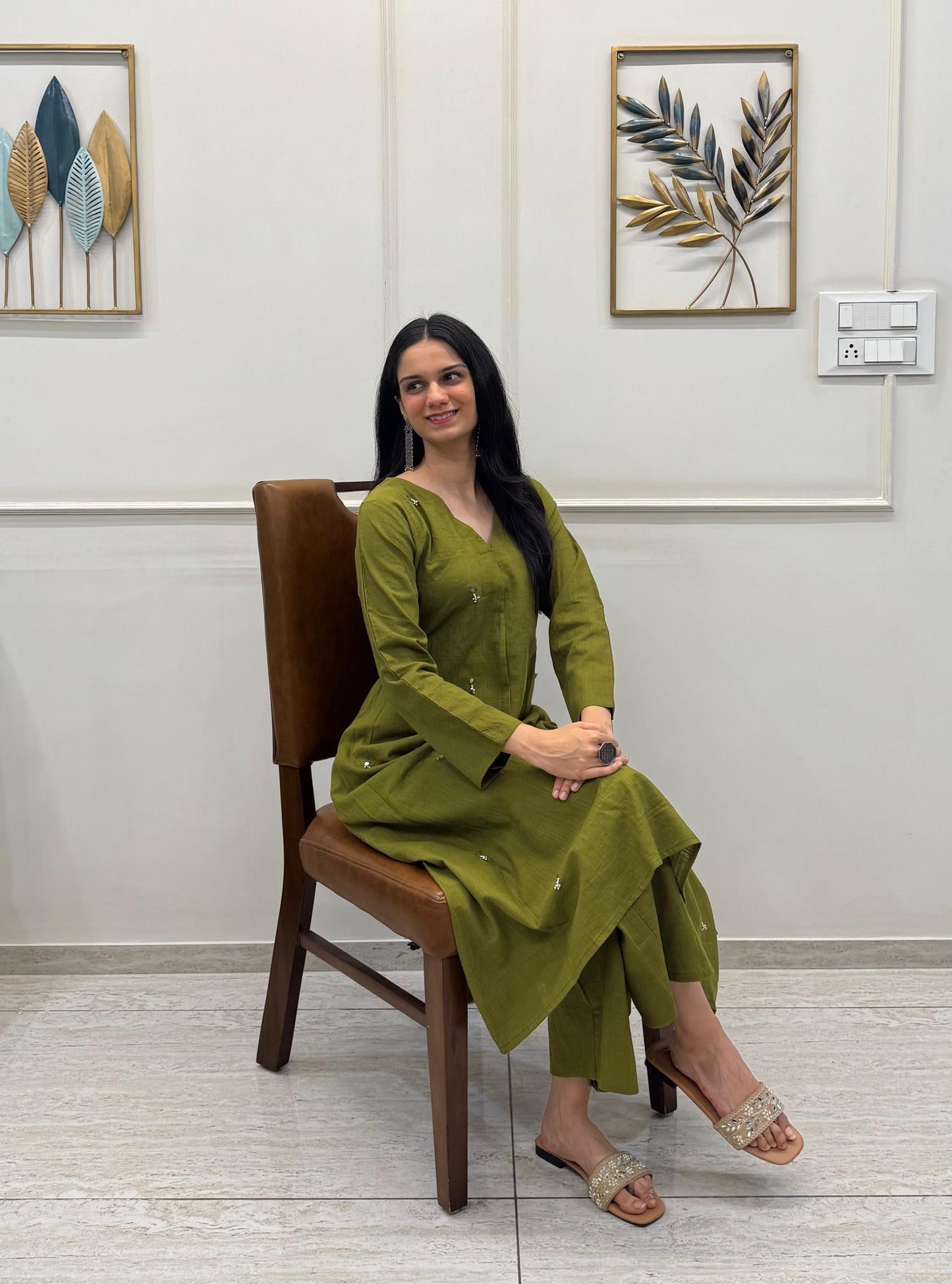 Olive Green A-Line Kurta Crafted In Breathable Cotton And Adorned With Mirror Handwork And Dainty Pearl Tassels.