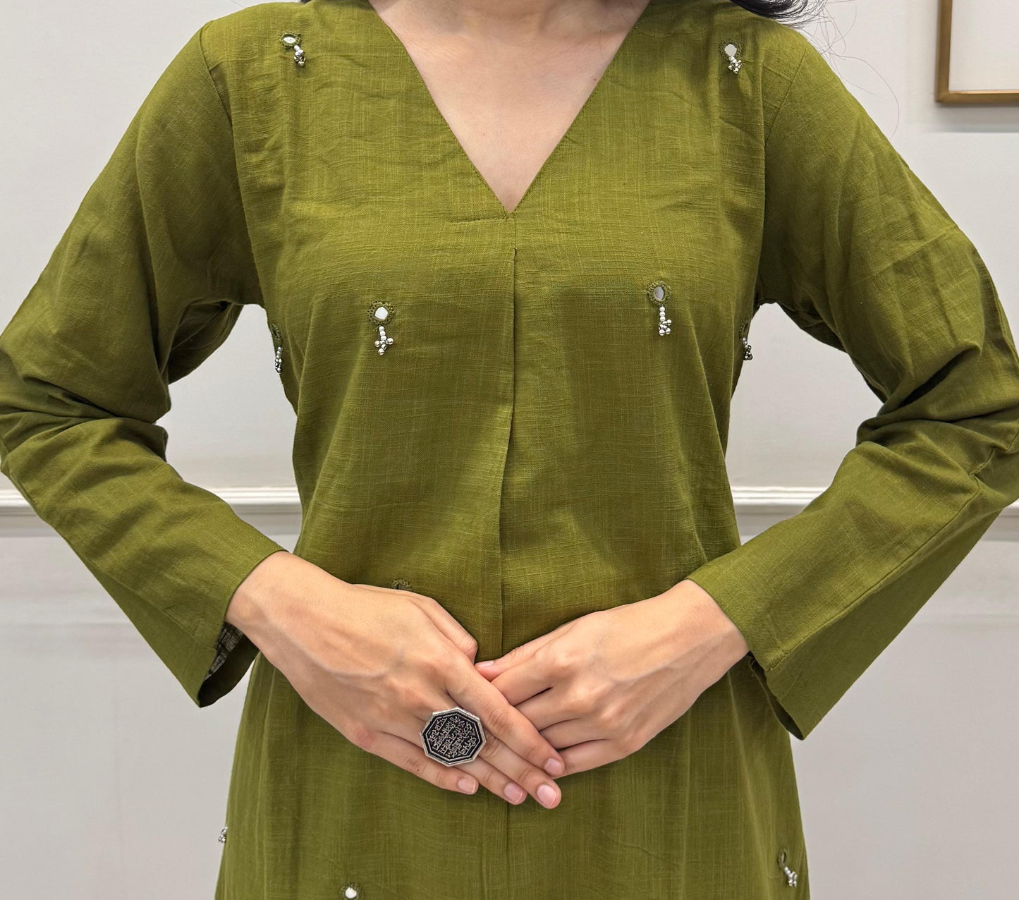 Olive Green A-Line Kurta Crafted In Breathable Cotton And Adorned With Mirror Handwork And Dainty Pearl Tassels.
