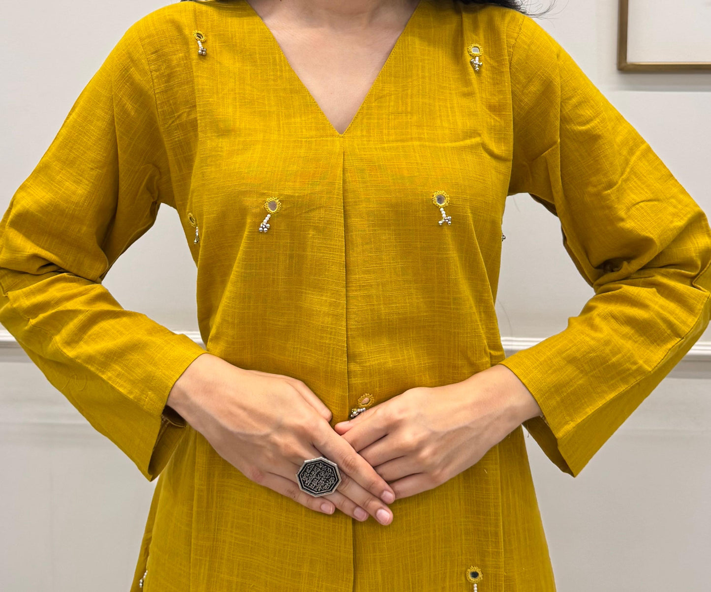 Yellow A-Line Kurta Pant Set In Breathable Cotton And Adorned With Mirror Handwork And Dainty Pearl Tassels.