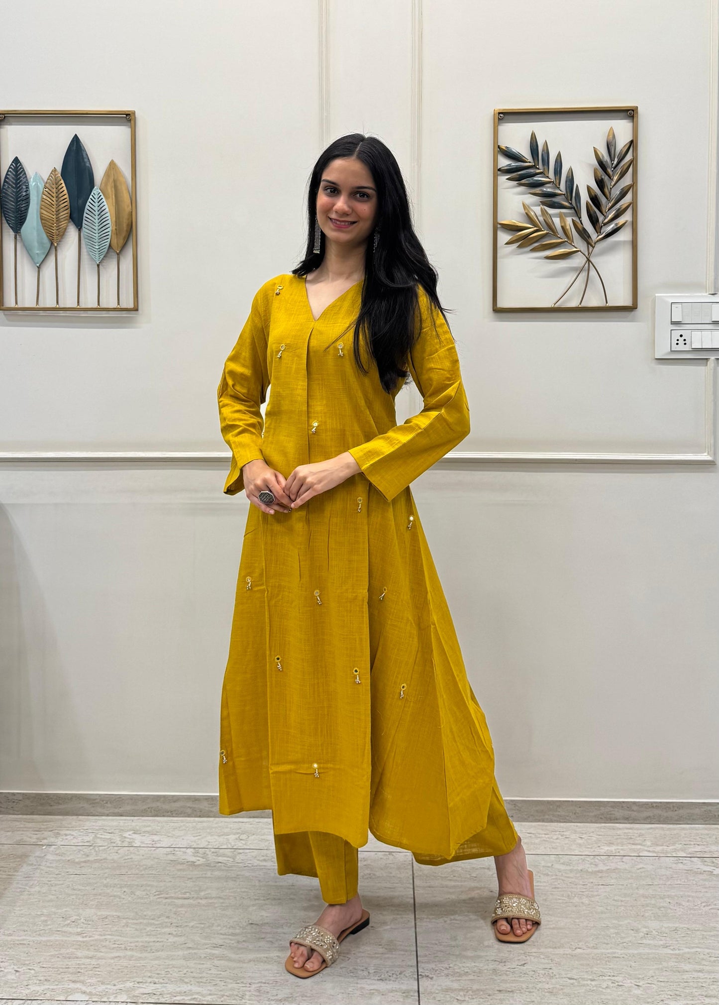 Yellow A-Line Kurta Pant Set In Breathable Cotton And Adorned With Mirror Handwork And Dainty Pearl Tassels.